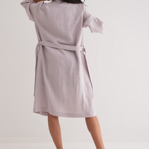 May include: A long, light purple linen robe with a tie belt. The robe is worn by a person standing on a white background.
