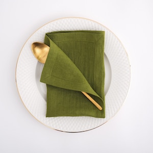 Elegant table setting with a Moss Green linen napkin, reflecting the best flax textiles and premium European quality sold by the yard at a linen fabric store.