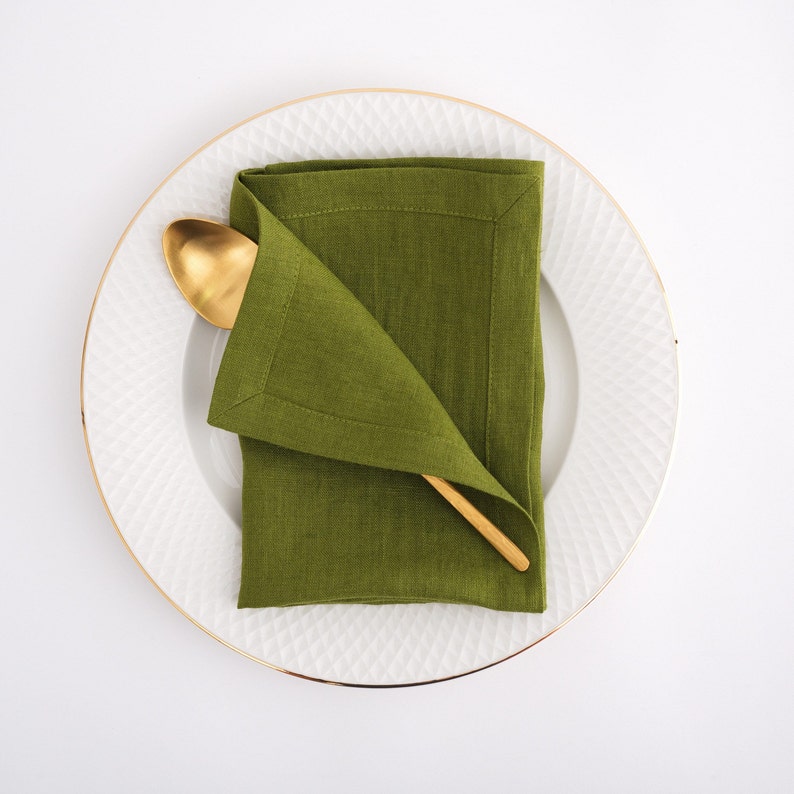 Elegant table setting with a Moss Green linen napkin, reflecting the best flax textiles and premium European quality sold by the yard at a linen fabric store.