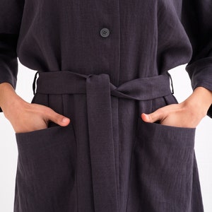 Close-up of a "Comfortable and Stylish Plus Size Linen Maxi Coat with Pockets," a green versatile washed linen duster tied at the waist.