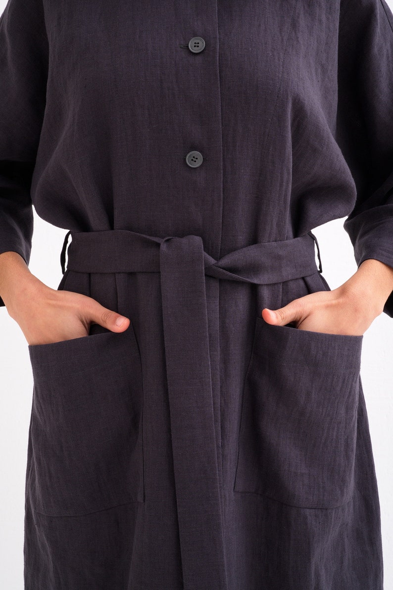 Close-up of a "Comfortable and Stylish Plus Size Linen Maxi Coat with Pockets," a green versatile washed linen duster tied at the waist.
