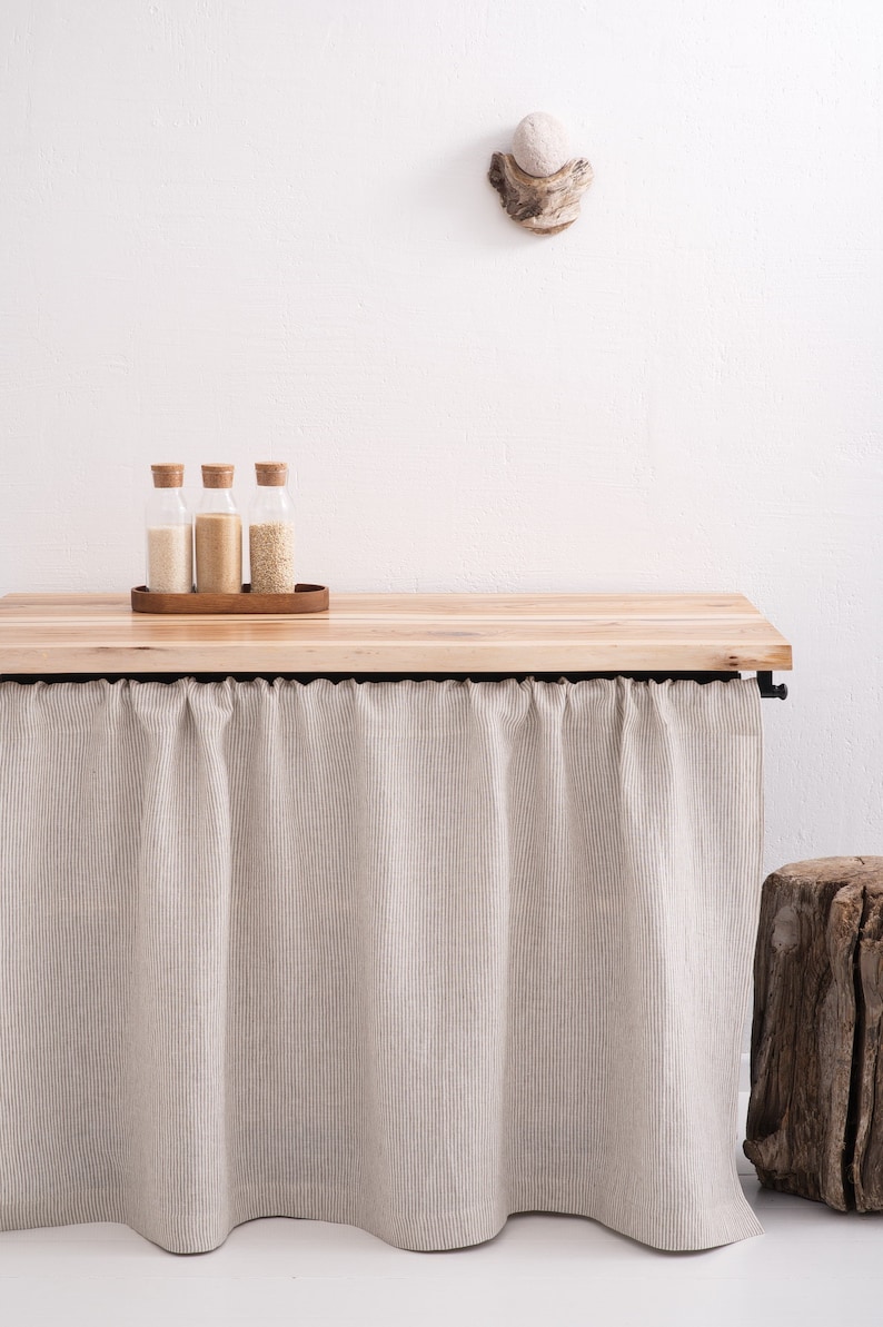A stonewashed natural striped linen curtain in white, custom-sized for kitchen cupboards or bathroom shelves, certified eco-friendly by OEKO-TEX.