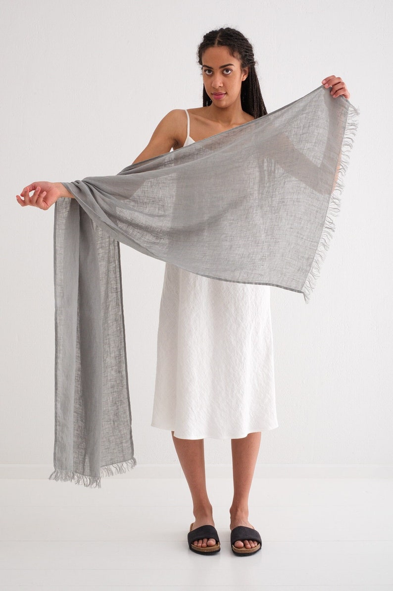 This linen scarf, crafted from washed linen, offers a lightweight feel and classic natural tones.