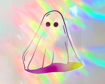 May include: A white ghost with two black eyes, outlined in black, on a holographic background.