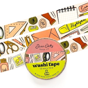 May include: A roll of washi tape labeled Boss Dotty Paper Co. 15 mm x 10 m, featuring a pattern of stationery items like rulers, scissors, ink bottles, and snail stamps. The tape is displayed against a background of the same repeating design.