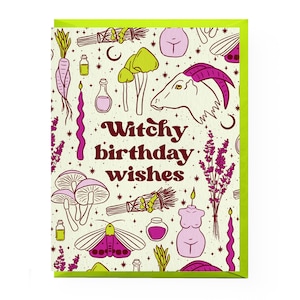 May include: A greeting card with a cream background and pink and green illustrations of various witchy items, including mushrooms, candles, a goat, and a wand. The text "Witchy birthday wishes" is written in a pink and brown font.