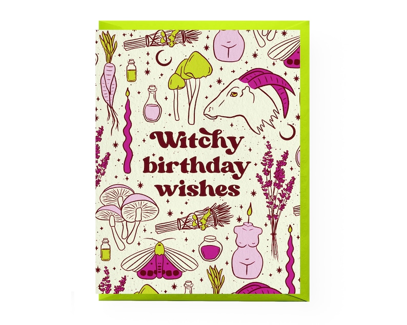 May include: A greeting card with a cream background and pink and green illustrations of various witchy items, including mushrooms, candles, a goat, and a wand. The text "Witchy birthday wishes" is written in a pink and brown font.