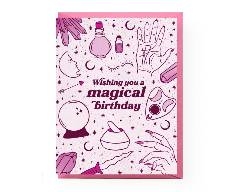 May include: Pink and white greeting card with a magical birthday message and illustrations of crystals, moons, a hand with a palm reading, a potion bottle, a crystal ball, a mortar and pestle, a dagger, and a Ouija board.
