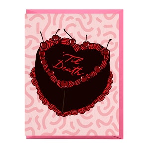May include: A pink card with a black and red heart-shaped cake with the words "Til Death" written in red on the cake. The cake is decorated with red cherries and frosting.