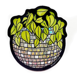 May include: A green plant growing out of a silver disco ball planter. The disco ball has a glittery, iridescent finish. The sticker has the text "BOSSDOTTY.COM" at the bottom.