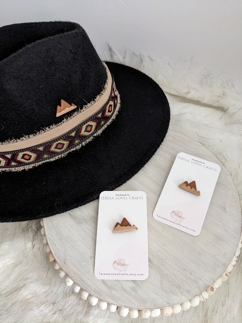 May include: Two small wooden mountain-shaped pins on white cards with the text "Handmade by TERESA LOVES CRAFTS" and "TeresaLovesCrafts.etsy.com".