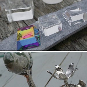 May include: A set of five silver metal decorative stands with a tree branch design. The stands are in various sizes and shapes, and some have leaves or flowers.