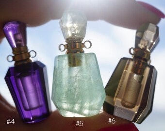 May include: Three crystal perfume bottles with gold stoppers and caps. The bottles are purple, green, and clear with a gold tint. The bottles are labeled #4, #5, and #6.