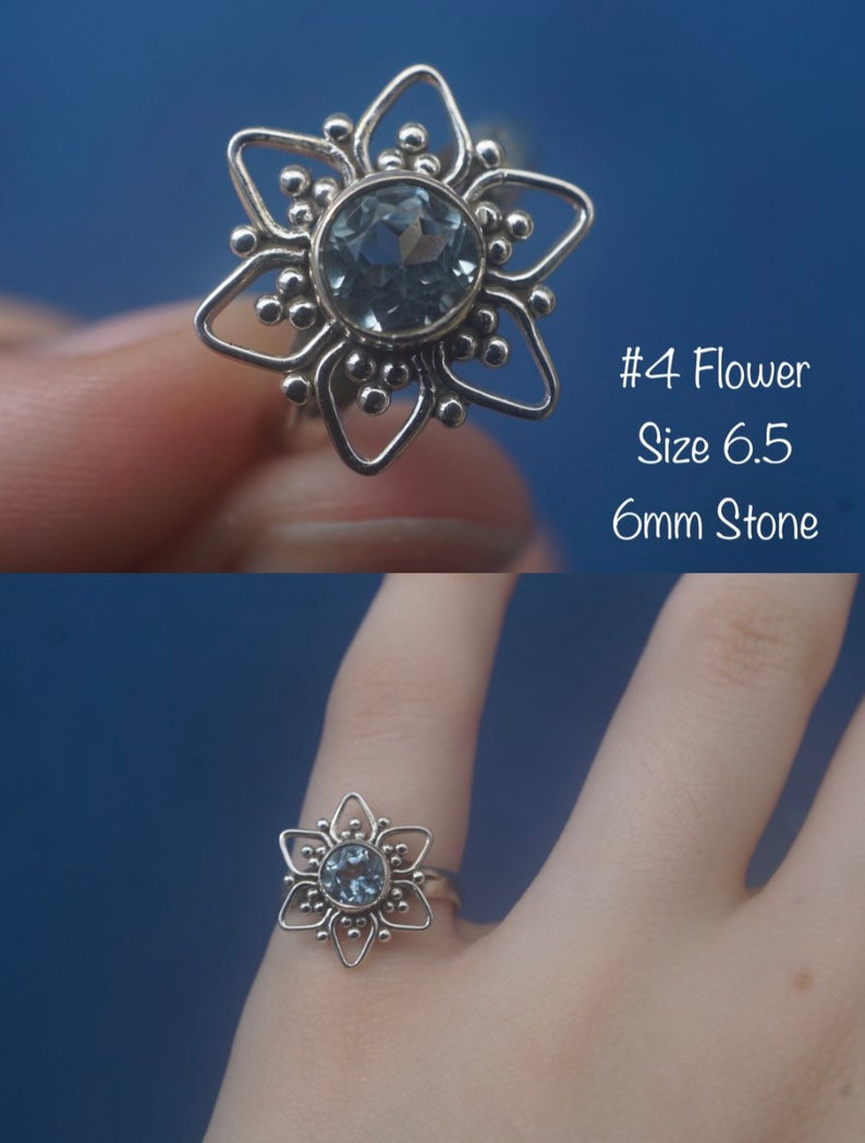 May include: A silver ring with a blue gemstone in the center, shaped like a flower with six points. The ring is size 6.5 and the stone is 6mm. #4 Flower