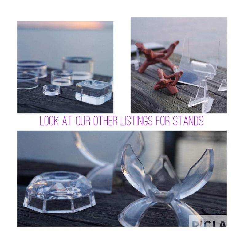 May include: Assortment of clear acrylic display stands for crystals, minerals, and other small objects. The stands come in various shapes and sizes, including round, square, and triangular.