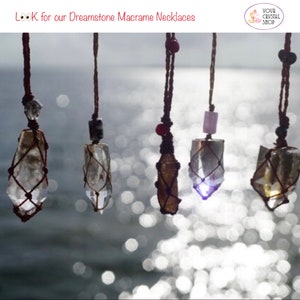 May include: Five crystal necklaces with macrame string, hanging against a blurred background of water and sunlight. The crystals are clear, brown, and purple. The text "LOOK for our Dreamstone Macrame Necklaces" is at the top of the image.