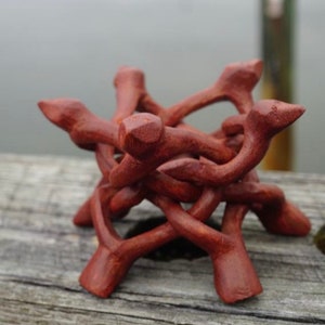 May include: A 6 inch extra large ornate wooden tripod stand, made of intricately carved wood, with a reddish-brown color.
