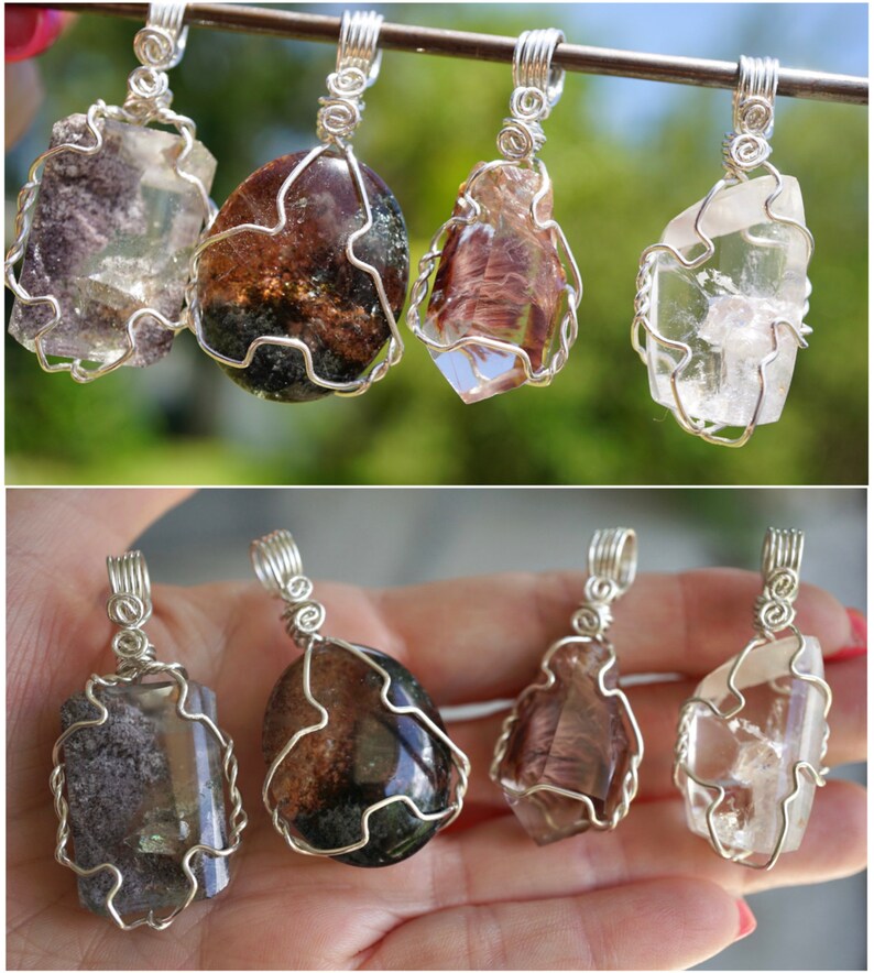 May include: Six wire-wrapped crystal pendants, featuring clear quartz, smoky quartz, and green amethyst crystals. The pendants are displayed on a silver wire and in a hand.