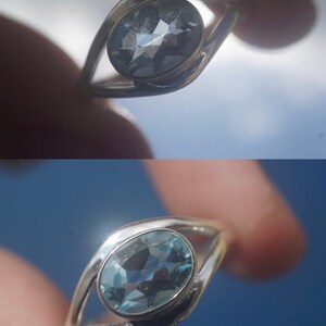 May include: Silver ring with a light blue oval gemstone. The ring is designed in an eye shape. The stone is 8x6 mm. #5 Eye Oval Size 9 8x6 Stone
