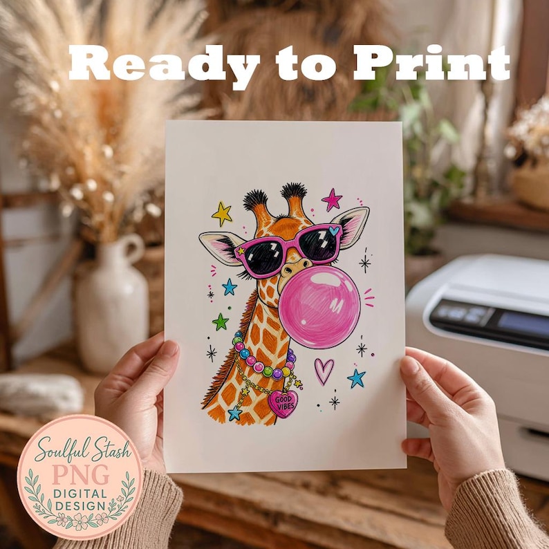 A person is holding up a piece of paper with a colorful illustration of a giraffe wearing sunglasses and surrounded by various decorative elements.