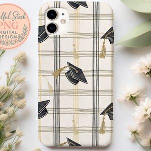 a phone case with a checkered pattern and graduation caps printed on it, placed on a white surface alongside some flowers and leaves.
