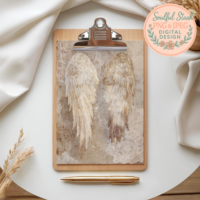 a wooden clipboard with a pair of angel wings printed on it, placed on a white surface. There is also a pen and a small plant in the background.