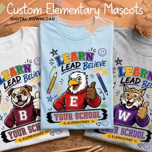 May include: Three t-shirts in white, light blue, and gray featuring graphic prints of a bulldog, an eagle, and a wildcat wearing hoodies. Each shirt displays the text Learn Lead Believe, Your School Elementary, and pencils, stars, and smiley faces.