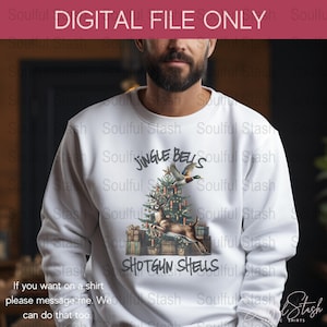May include: A white crewneck sweatshirt featuring a graphic print of a Christmas tree, a deer, and a flying duck, surrounded by gift boxes. The text JINGLE BELLS is printed above the graphic, and SHOTGUN SHELLS is printed below the graphic.