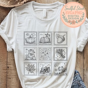 May include: White t-shirt with a grid of nine postage stamp-style illustrations depicting autumn harvest scenes. Designs include pumpkins, a scarecrow, an acorn, and a tractor. The shirt has a round logo that says "Soulful Stash SVG & PNG DIGITAL DESIGN".