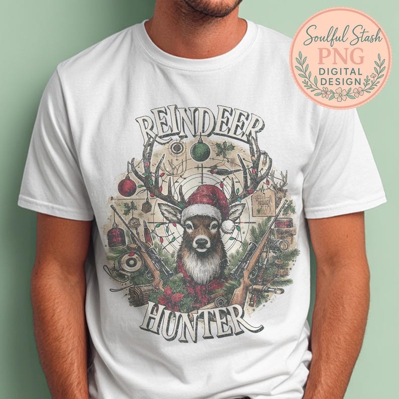 May include: White t-shirt featuring a deer wearing a Santa hat, antlers adorned with Christmas lights and ornaments, and two rifles. The text reads "REINDEER HUNTER" in a vintage style.