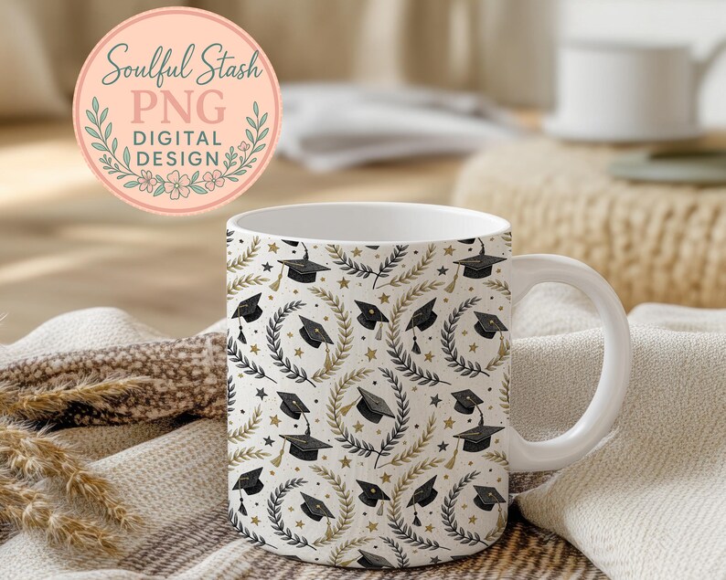 A white mug with a pattern of black graduation caps and laurels sits on a beige blanket, with a pink circular logo in the background that reads "Soulful Stash Png Digital Design".