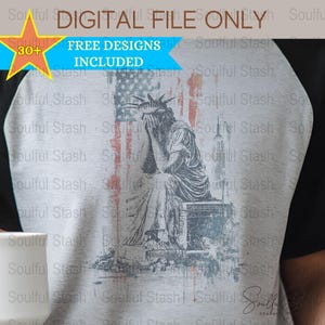 May include: A distressed graphic design of the Statue of Liberty with a distressed American flag in the background. The Statue of Liberty is depicted with her head in her hands, as if in sorrow. The design is in shades of gray, red, white, and blue.