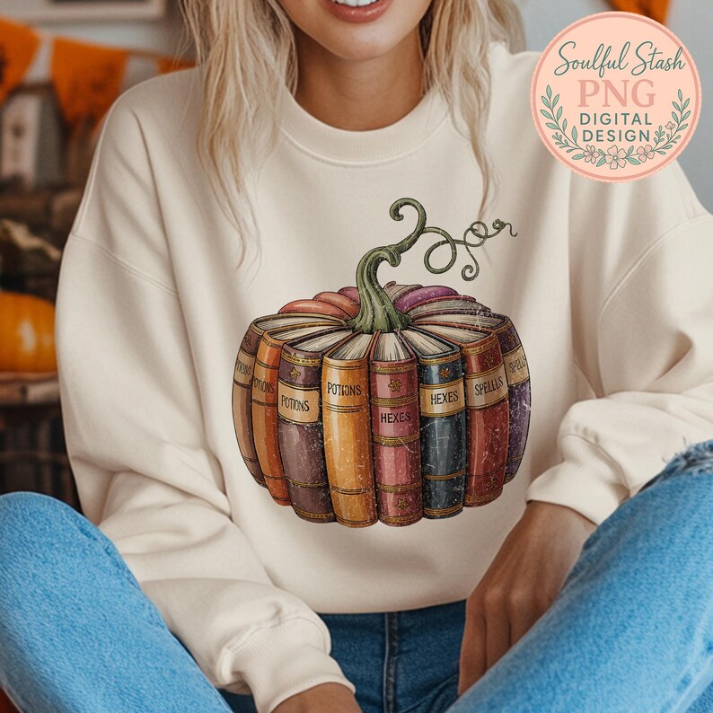 A woman wearing a white sweater with a graphic of a pumpkin filled with books, specifically spells, printed on it.