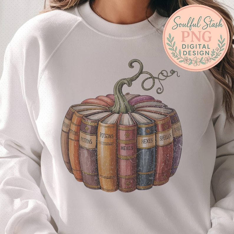 A white sweatshirt with a graphic design of a pumpkin containing a row of colorful books titled "POTIONS" and "HEXES".