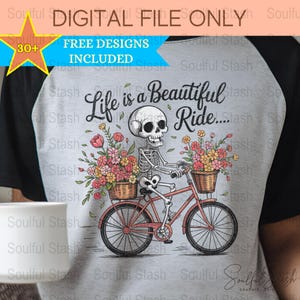 May include: A gray t-shirt with a black and white skeleton riding a bicycle with flowers in baskets. The text "Life is a Beautiful Ride..." is printed on the shirt.