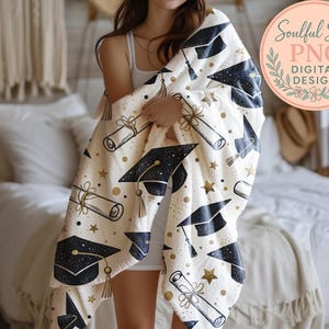 A person is standing in a bedroom, holding a white blanket with black graduation caps and stars printed on it.