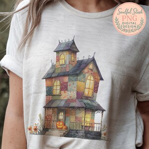 May include: A light-colored t-shirt featuring a colorful, patchwork-style illustration of a haunted house. The house has multiple windows, a porch, and a jack-o'-lantern. The text "Soulful Stash PNG DIGITAL DESIGN" is in a circular logo.