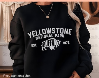 May include: Black sweatshirt with white text that reads "Yellowstone National Park" and a silhouette of a buffalo with the text "Buffalo" above it and "Est. 1872" below it.