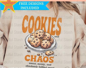 May include: A beige sweatshirt with the text "COOKIES and CHAOS sweet, messy, and absolutely falling apart" in orange. The design features a plate of chocolate chip cookies.