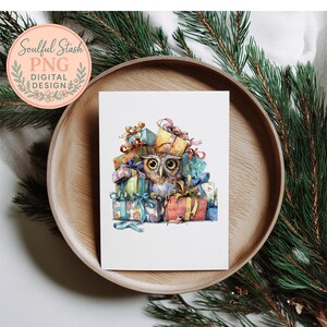 A white card with a colorful illustration of an owl sitting on a pile of wrapped gifts, surrounded by pine branches.