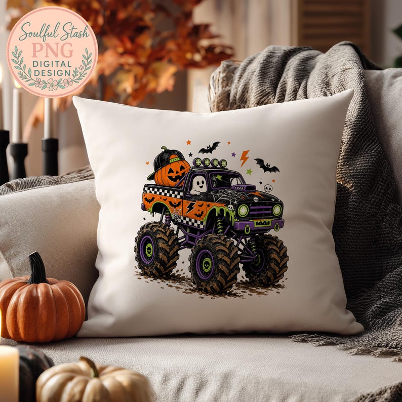 A pillow with a Halloween-themed graphic of a monster truck, featuring a jack-o-lantern and bats, is displayed on a couch.