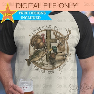 May include: A beige and black baseball style t-shirt with a vintage-style graphic of a cross, a turkey, a deer, a fish, and a duck. The graphic is surrounded by a circle with the text "Let us thank Him for our food" and "Genesis 9:3".