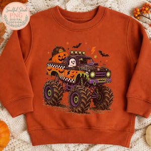 An orange sweatshirt with a Halloween-themed graphic of a monster truck with a jack-o-lantern passenger.