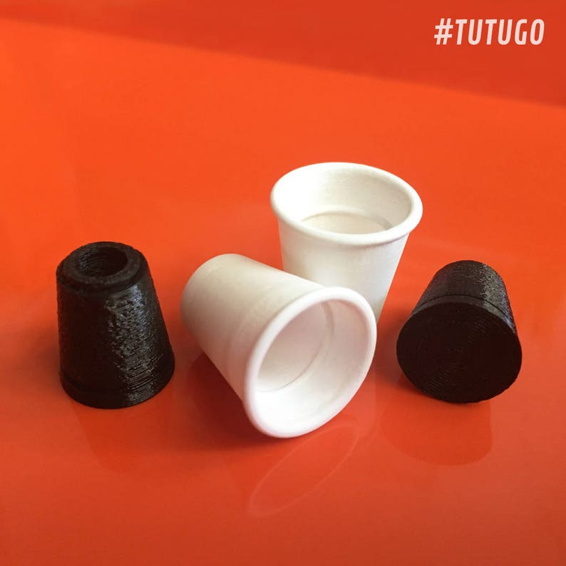 May include: Three small cups, two white and one black. The white cups are made of paper and the black cup is made of plastic. #TUTUGO