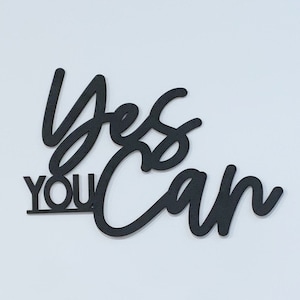 The words "yes you can" laser cut wood sign.