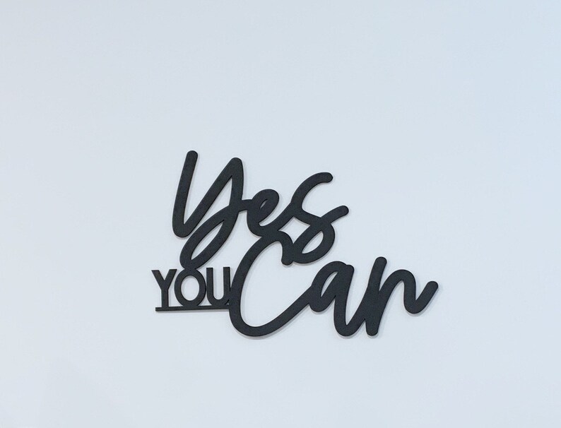 The words "yes you can" laser cut wood sign.