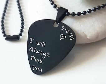 May include: Black guitar pick necklace with a silver inscription that reads "I will always pick you" and "5/8/16" with a heart symbol.