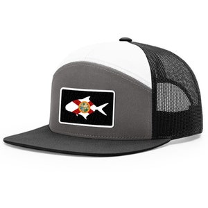 May include: A gray and white trucker hat with a black mesh back. The hat features a patch of a fish with the Florida state flag on it.