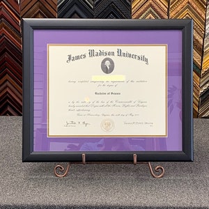 May include: A framed diploma from James Madison University, with a purple mat and a black frame. The diploma is for a Bachelor of Science degree. The text on the diploma reads "having completed satisfactorily the requirements of this institution for the degree of Bachelor of Science is by the authority of the Board of the Commonwealth of Virginia hereby awarded that Degree with all the Honors, Rights and Privileges thereunto appertaining. Given at Harrisonburg, Virginia the sixth day of May 2017.  Jonathan P. Alger, President,  Vanessa Evans Grimes, Secretary."