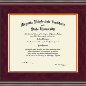 May include: A framed diploma from Virginia Polytechnic Institute and State University, with the name "Jordan Thompson" printed on the document. The diploma has a maroon frame with an orange mat.